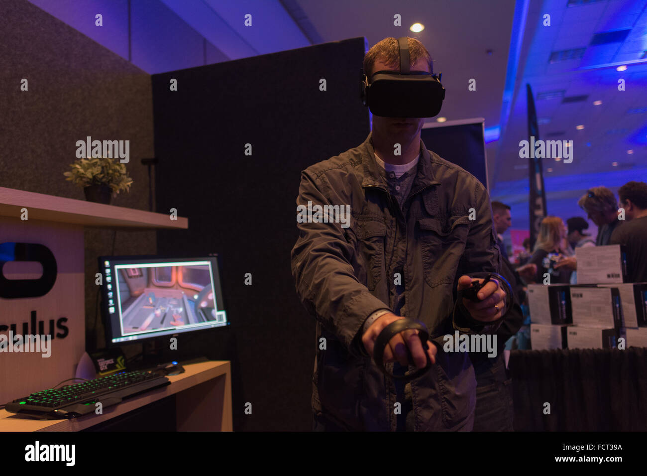 Los Angeles, USA - January 23, 2016: Man tries virtual reality headset and hand controls during VRLA Expo Winter, virtual realit Stock Photo