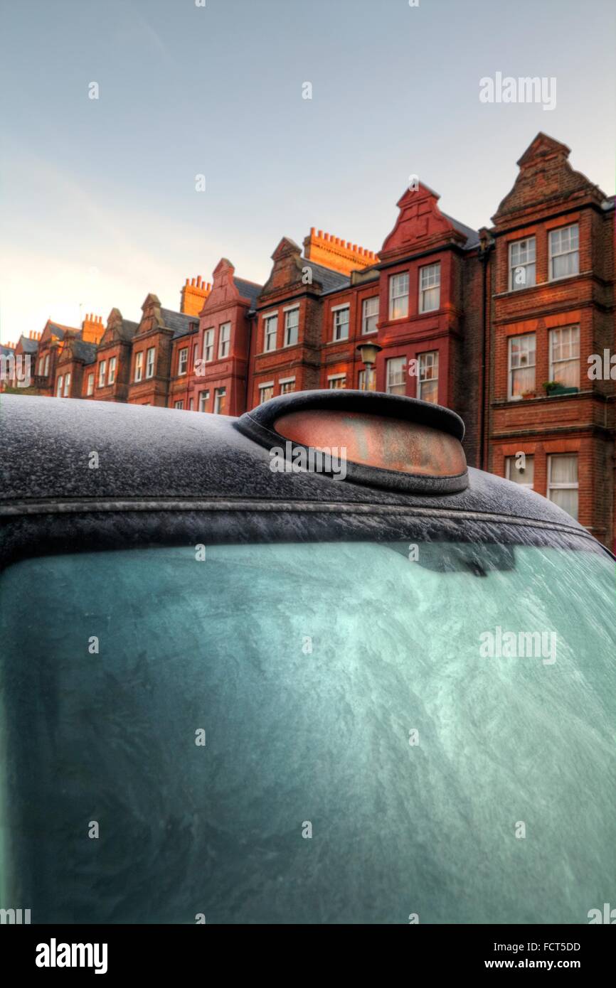 Black Taxi Cab in Frost, Terrace Street, Cold Sunny London Winter Morning Stock Photo
