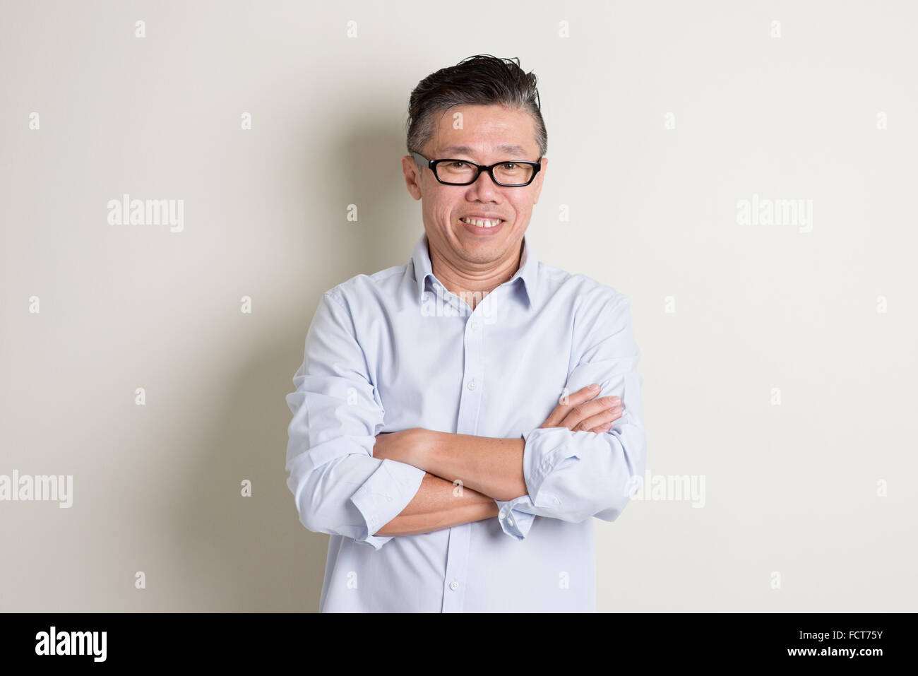 Portrait of confident single mature 50s Asian man in casual business ...