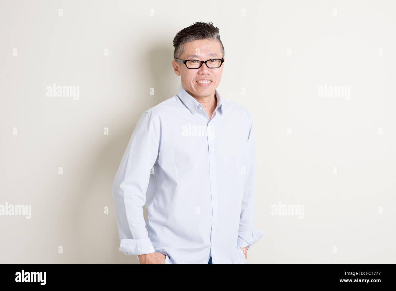 Portrait of confident single mature 50s Asian man in casual business ...