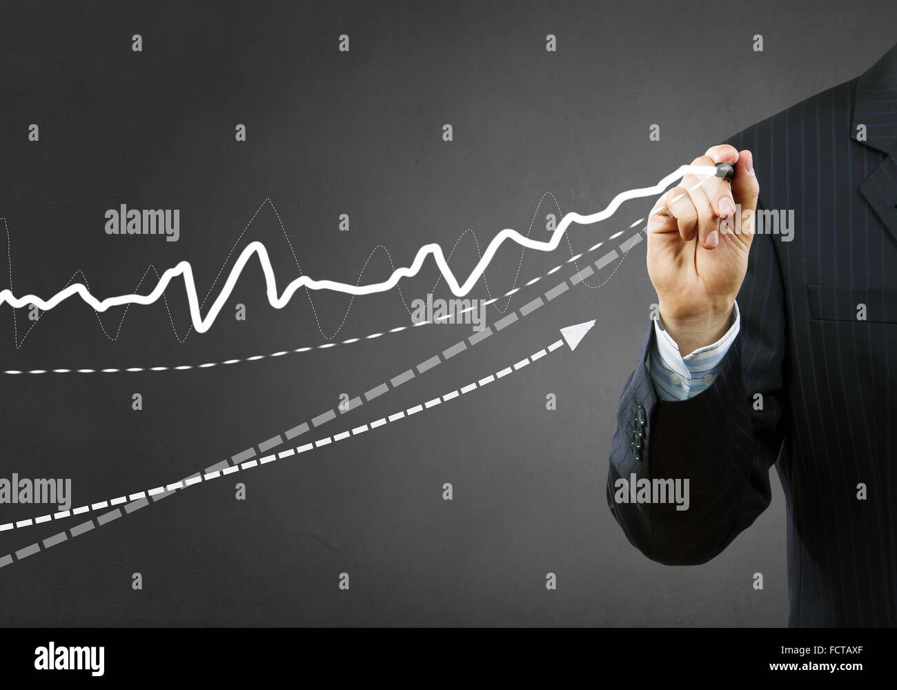 Businessman hand drawing business graphs on media screen Stock Photo ...