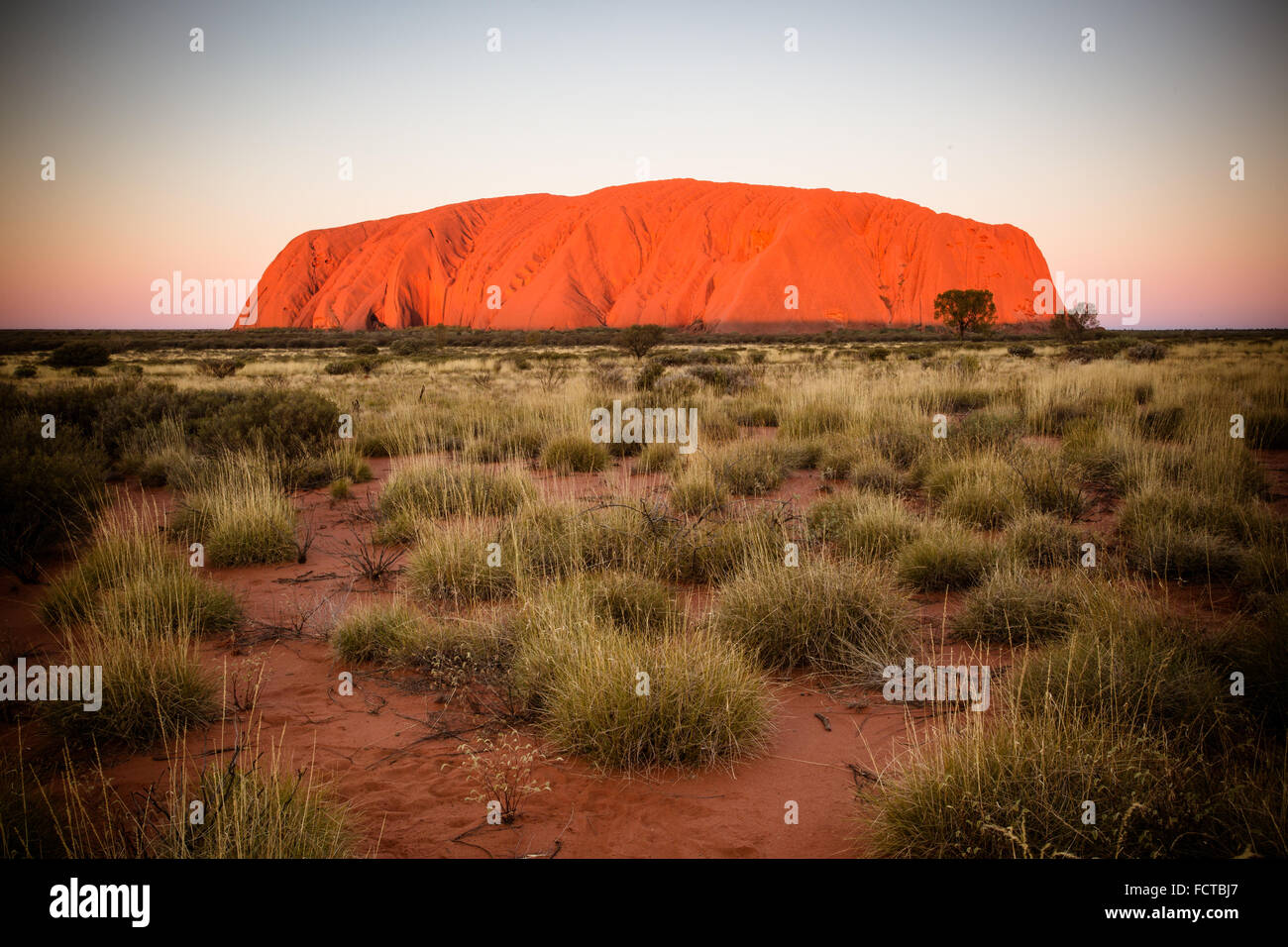 Majestic Uluru at sunset on a clear winter's evening in the Northern Territory, Australia Stock Photo
