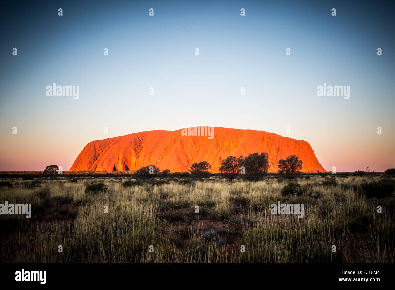 Majestic Uluru at sunset on a clear winter's evening in the Northern Territory, Australia Stock Photo