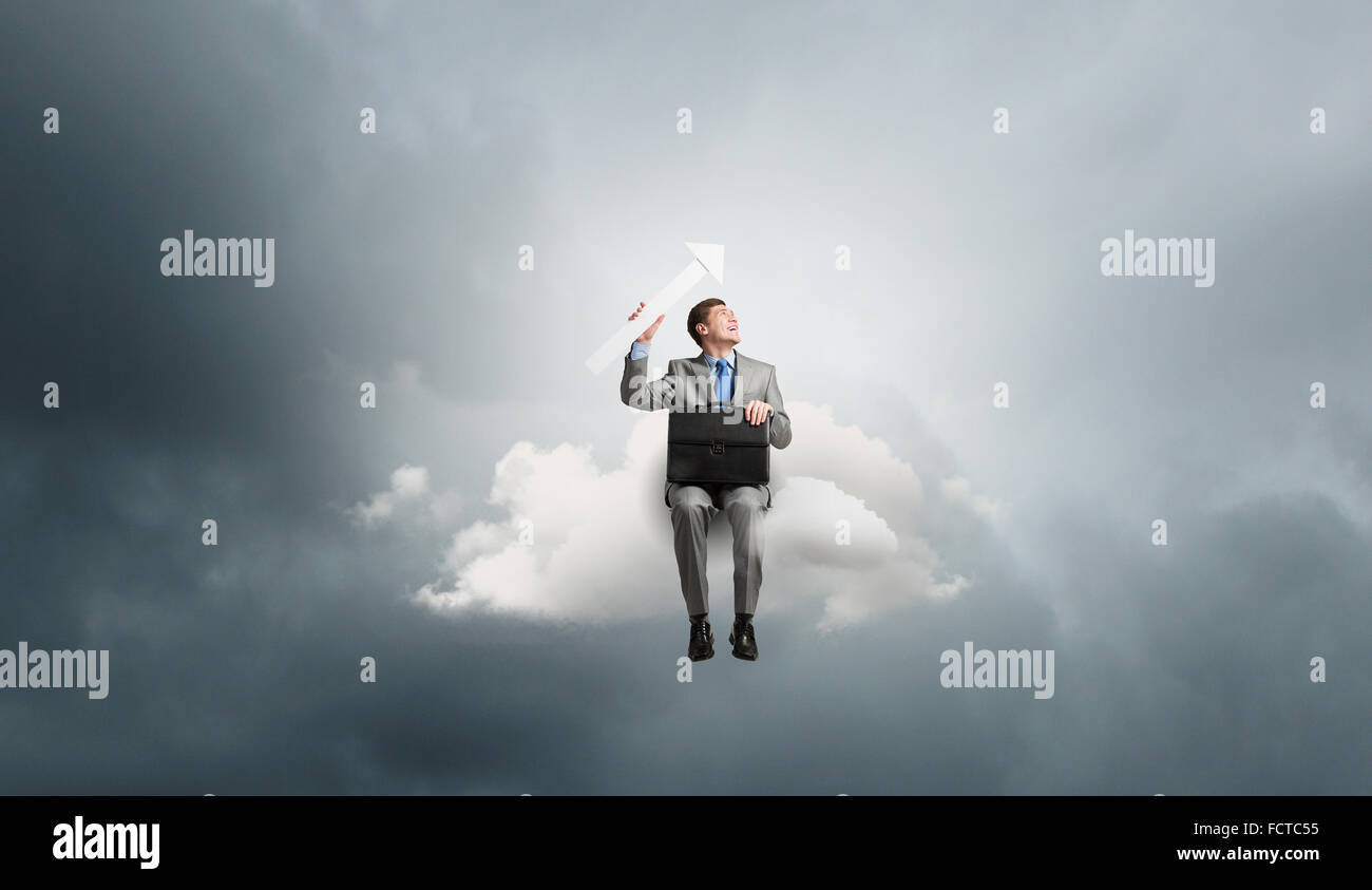 Young smiling businessman sitting on cloud with arrow in hands Stock ...