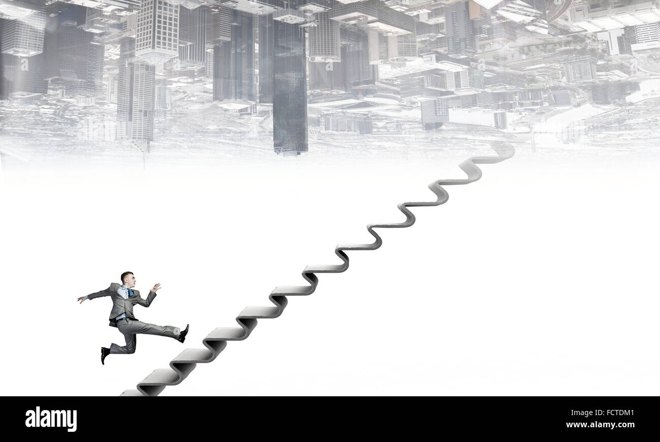 Young businessman running up on staircase representing success concept ...