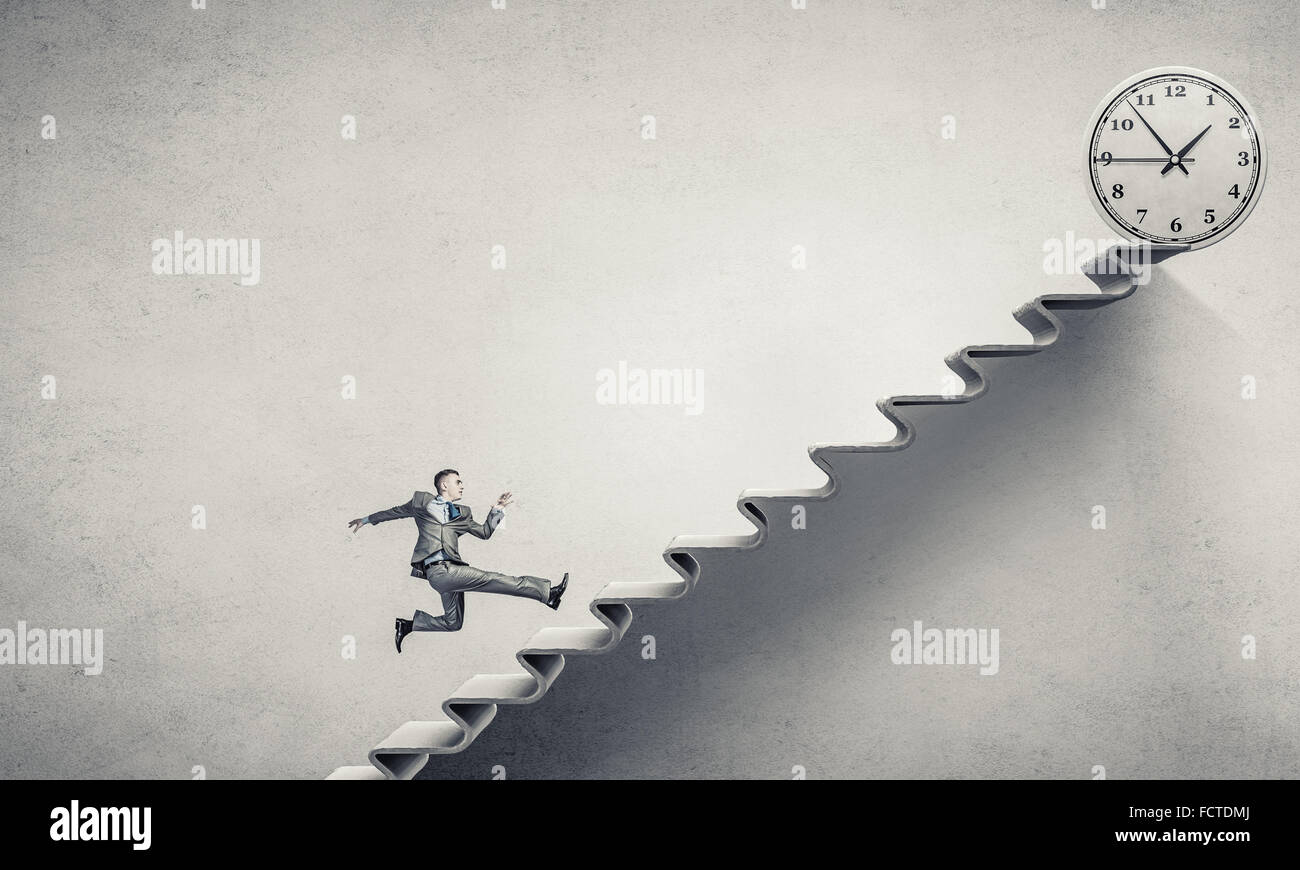 Young businessman running up on staircase representing success concept ...