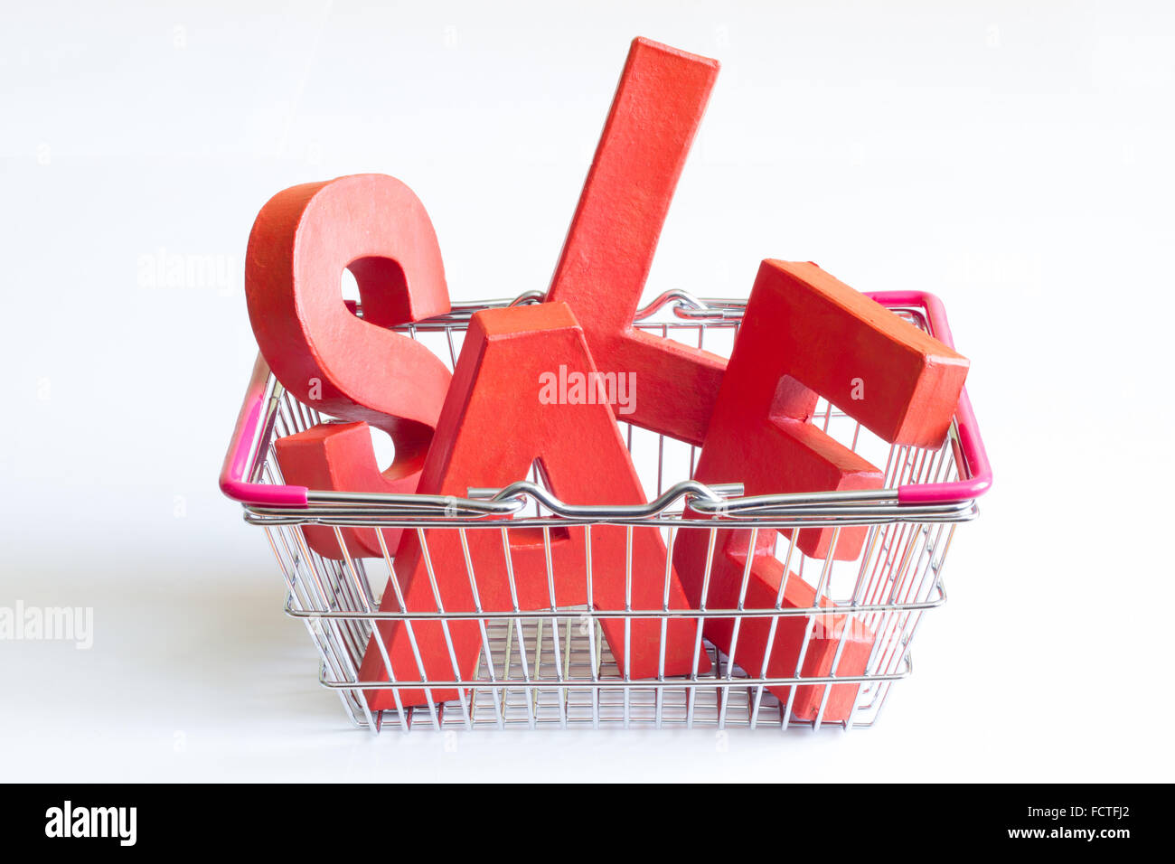 Sale red letters and a shopping basket on a white background Stock Photo