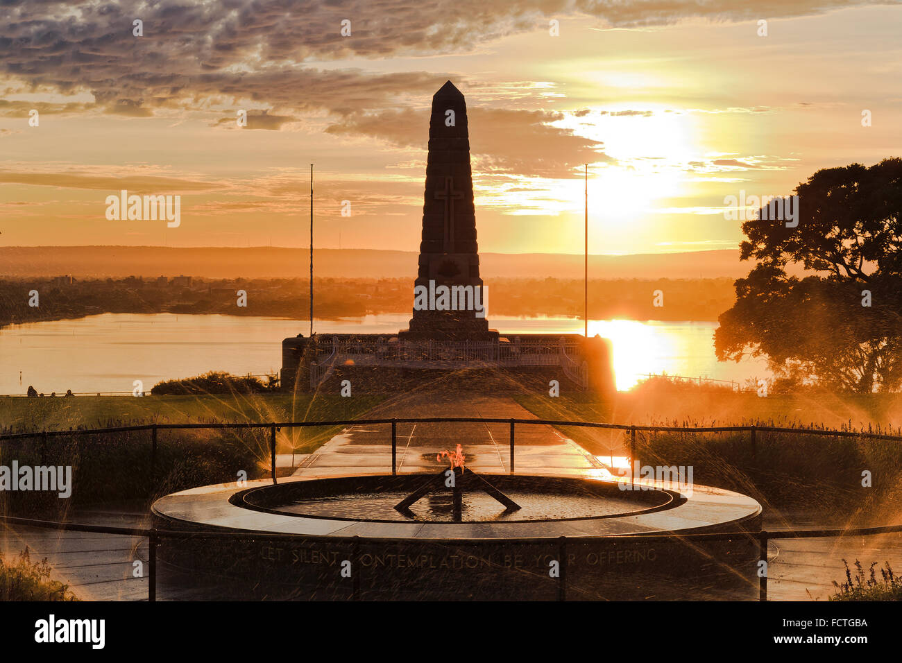 ANZAC commemorate memorial obelisk in Kings park of Perth, Western Australia, at sunrise against rising sun reflecting in swan Stock Photo