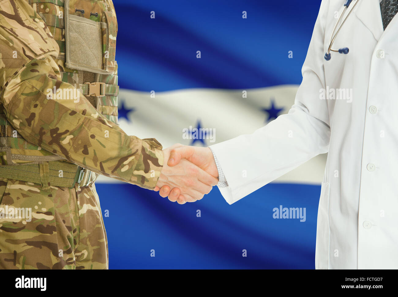 Soldier in uniform and doctor shaking hands with national flag on background - Honduras Stock Photo