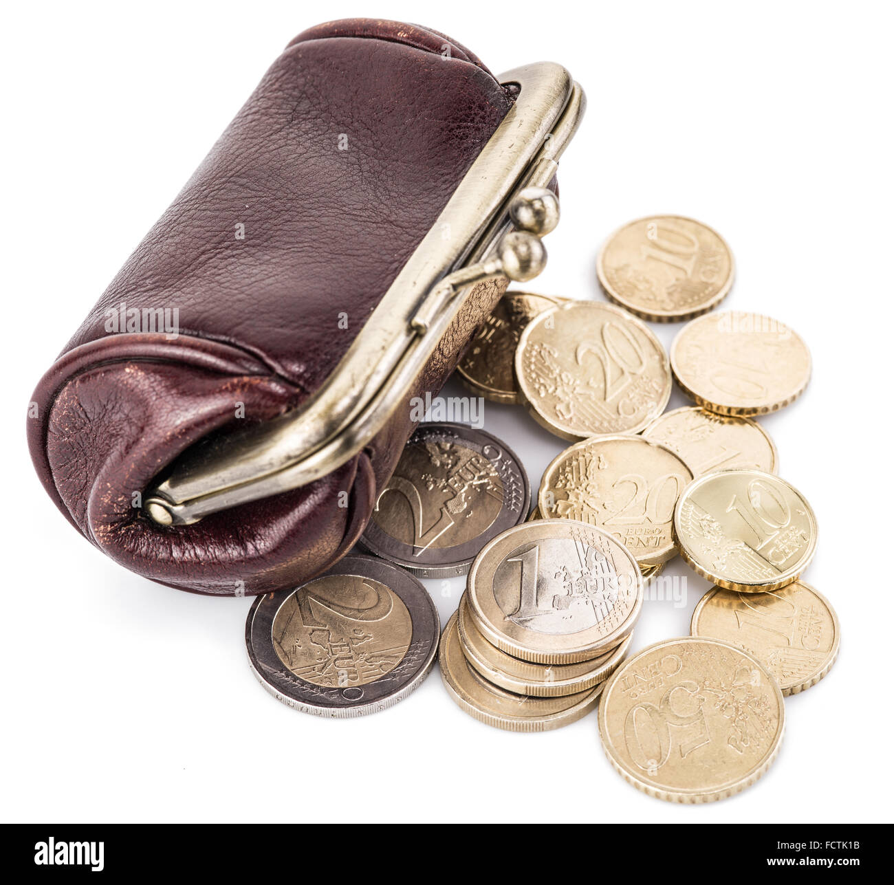 Small leather purse for coins and coins near it. Isolated on white background. Stock Photo