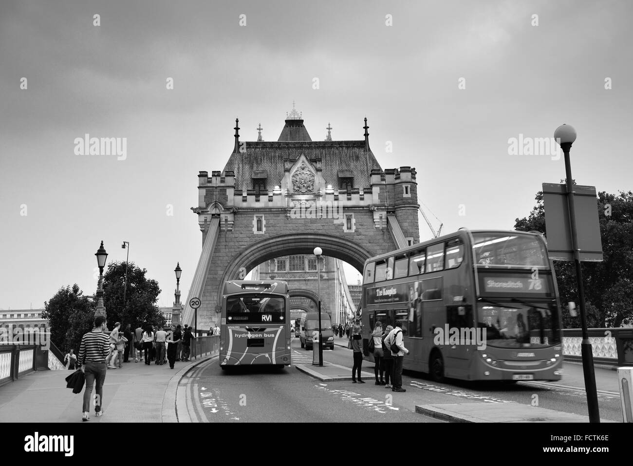 LONDON, UK - SEP 25: Tower Bridge with tourists and traffic on September 25, 2013 in London, UK. It is one of the iconic architectures in London and one of the most famous bridges in the world. Stock Photo