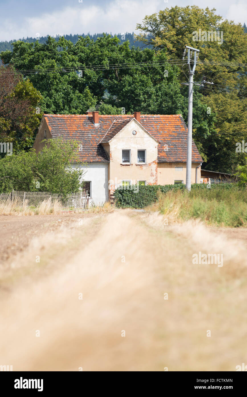 Dirt track to an old shabby house in Ścinawka Średnia in the country side in southern Poland Stock Photo
