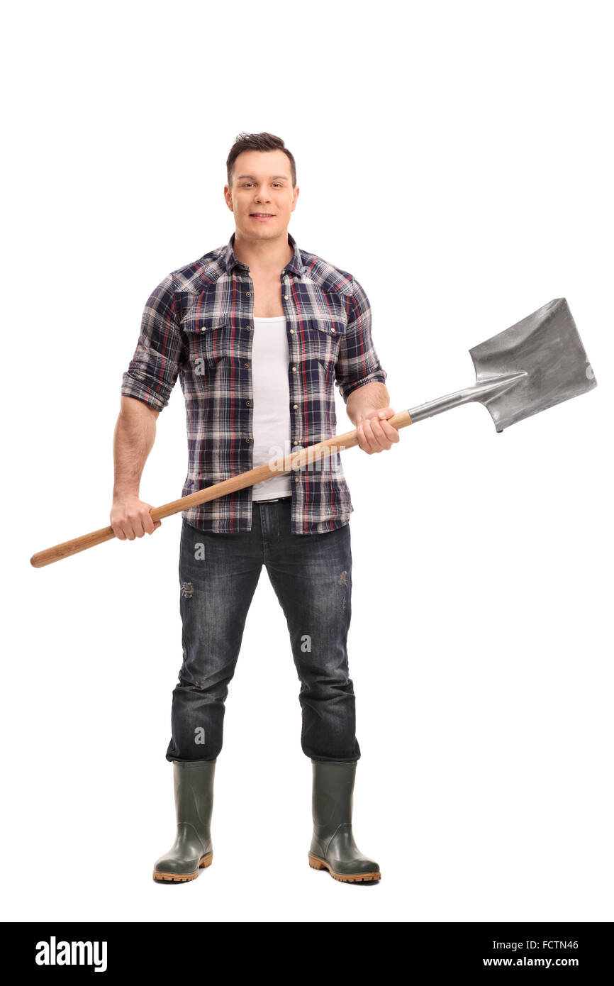 Full length portrait of a young agricultural worker holding a shovel ...