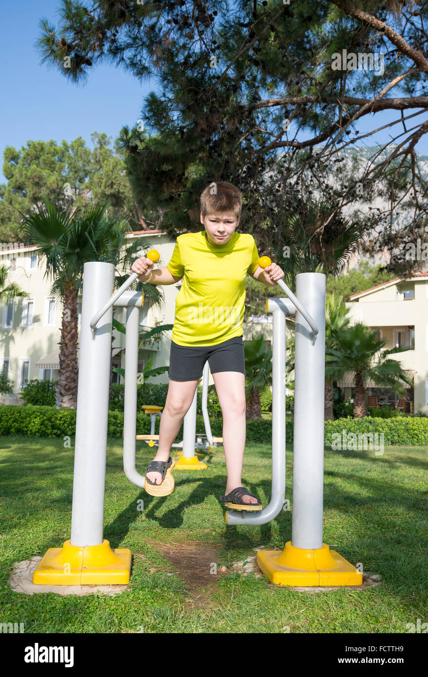 Boy doing fitness trainers on street Stock Photo