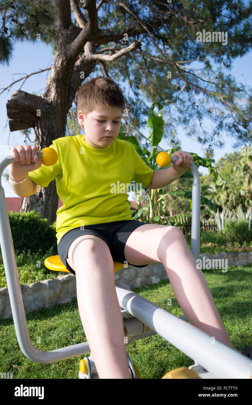 Boy doing fitness trainers on street Stock Photo