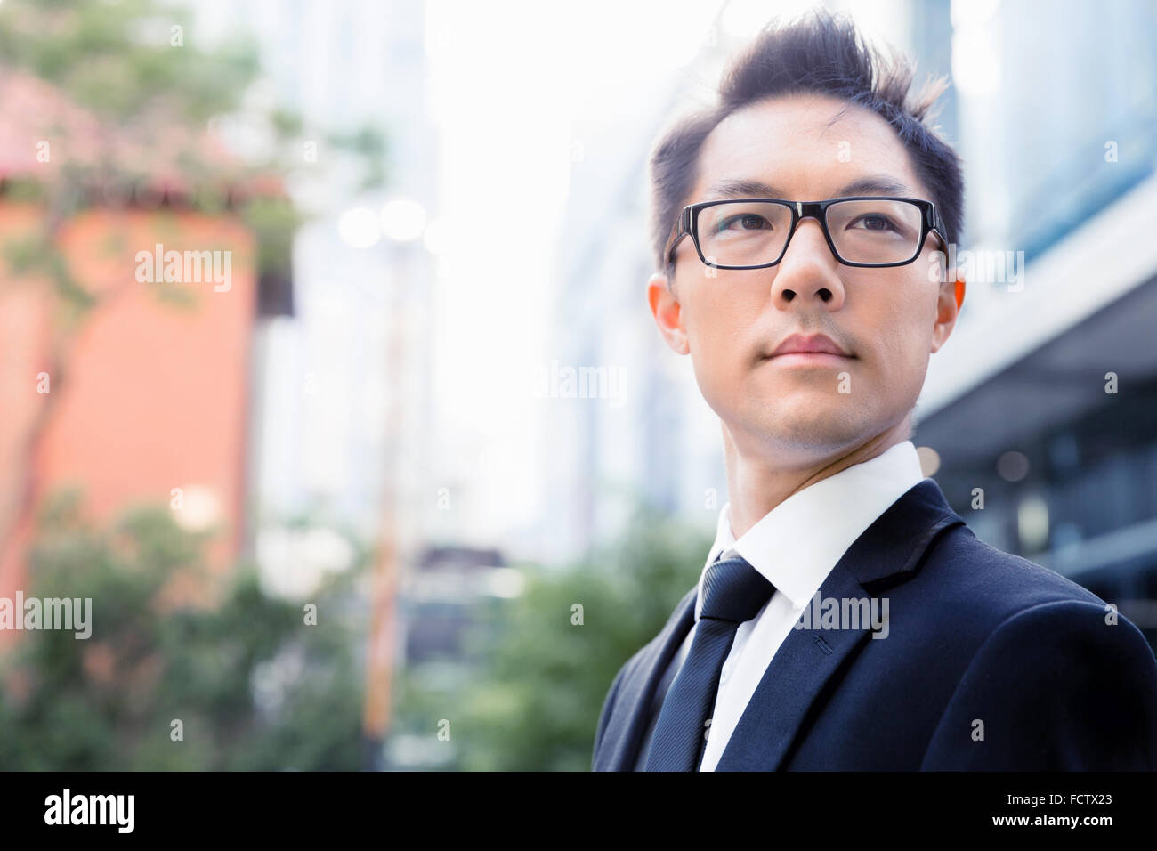 Businessman standing outdoors in city business district Stock Photo - Alamy
