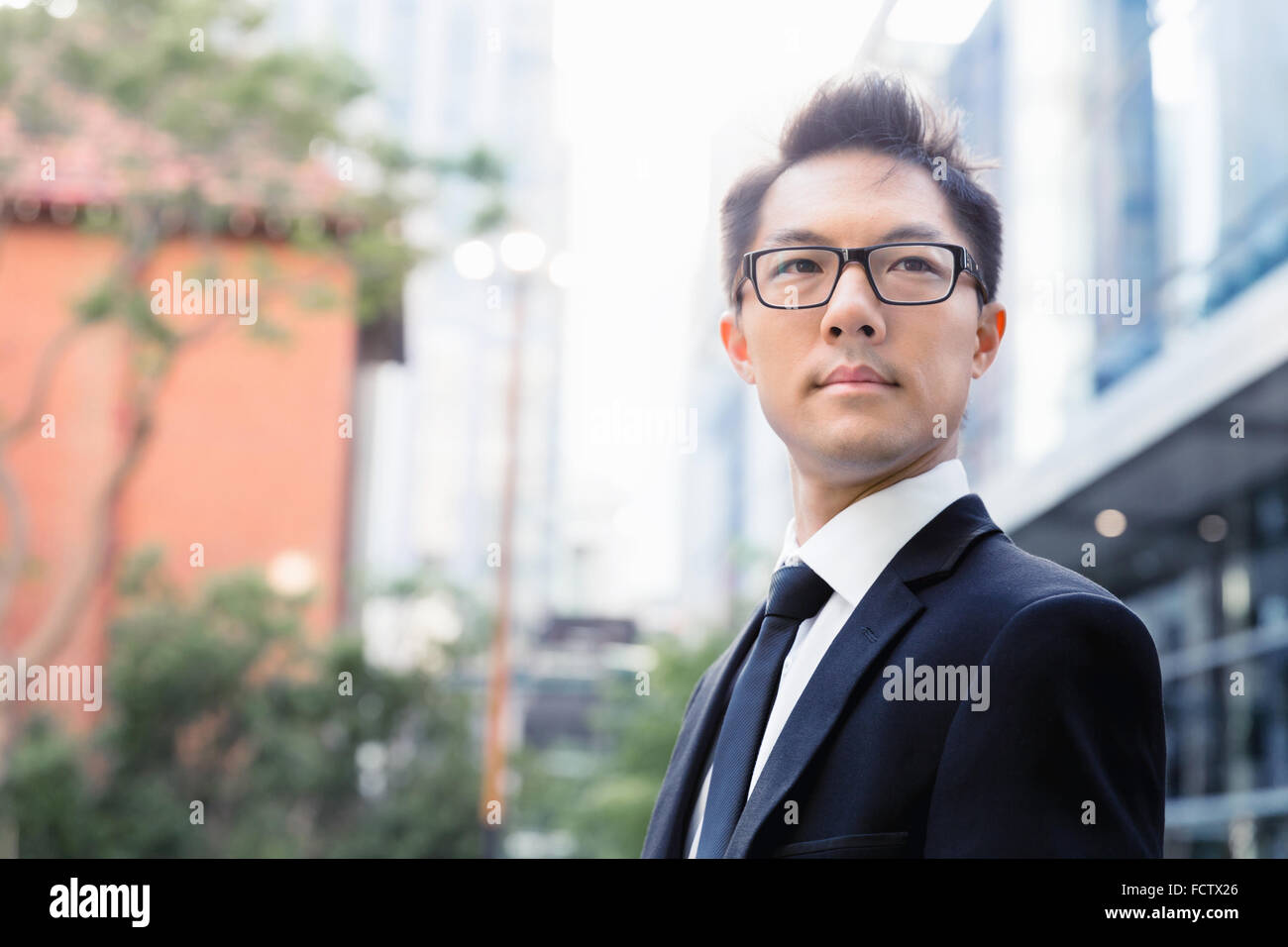 Businessman standing outdoors in city business district Stock Photo - Alamy
