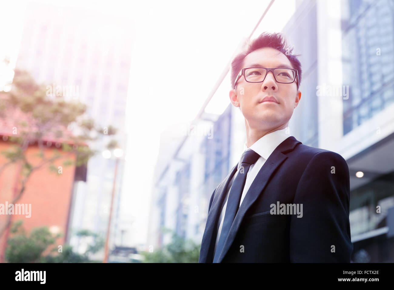Businessman standing outdoors in city business district Stock Photo - Alamy