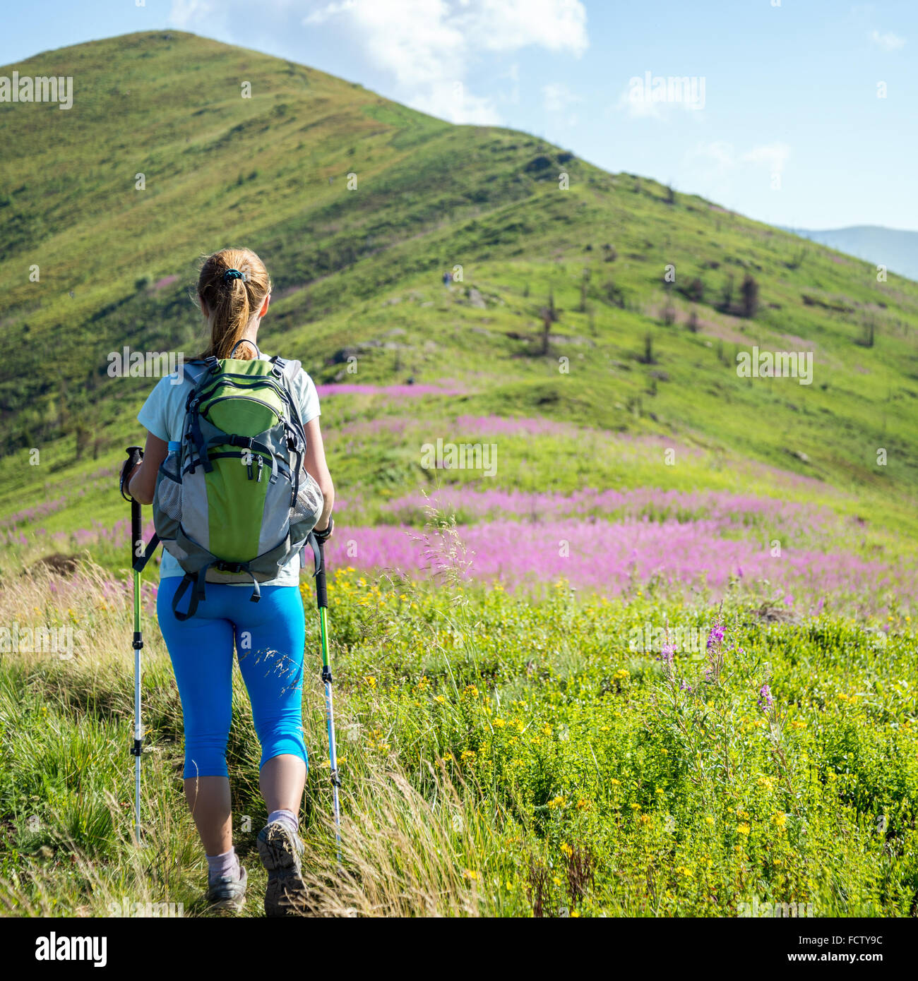 Young woman hiking in the mountains Stock Photo - Alamy