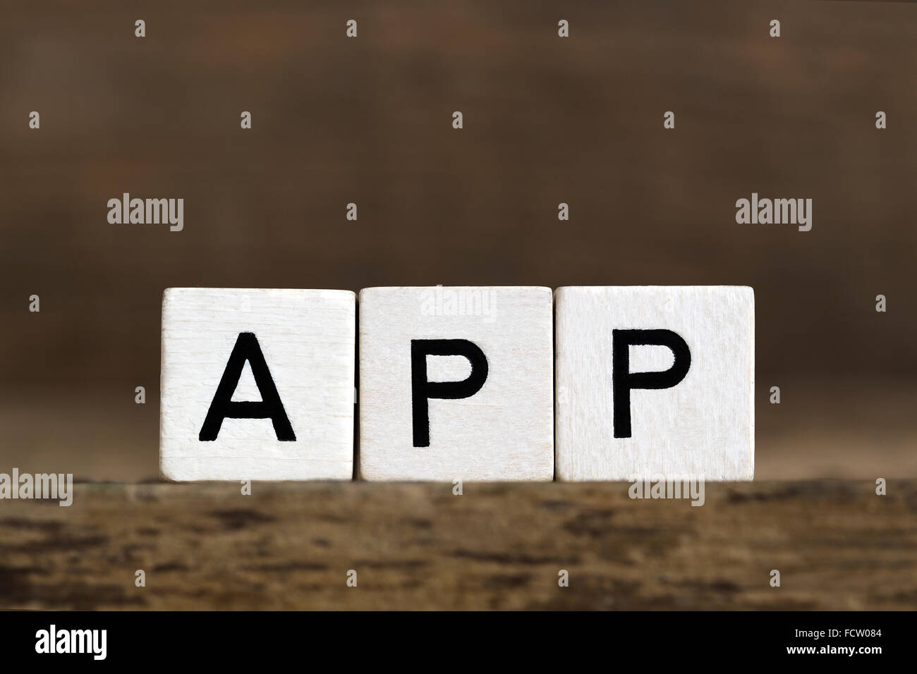 The word app written in cubes on wooden background Stock Photo