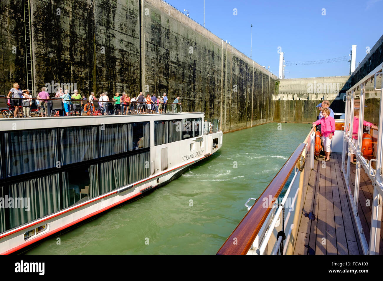 GABCIKOVO LOCK ON RIVER DANUBE IN SLOVAKIA WITH CRUISE BOATS WAITING TO GO THROUGH LOCK TOURISTS ON BOAT DECKS Stock Photo