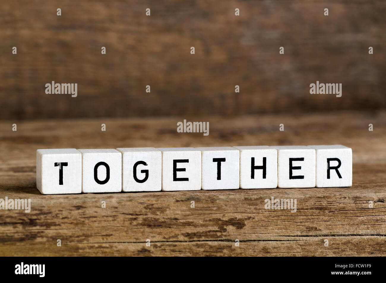 The word together written in cubes on wooden background Stock Photo