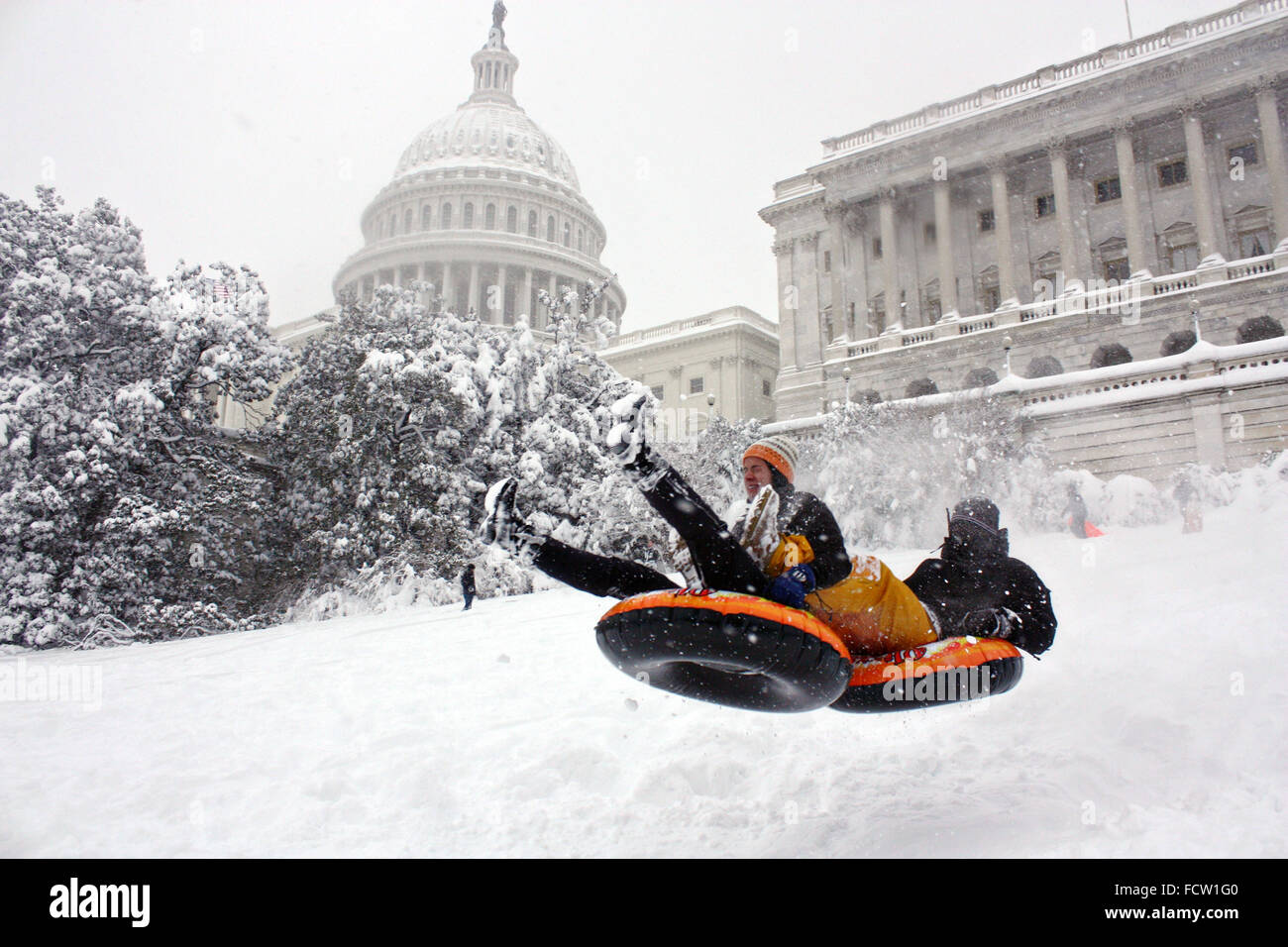 Residents take advantage a snowstorm to ride snow sleds down the slope on Capitol Hill February 6, 2010 in Washington, DC. Stock Photo