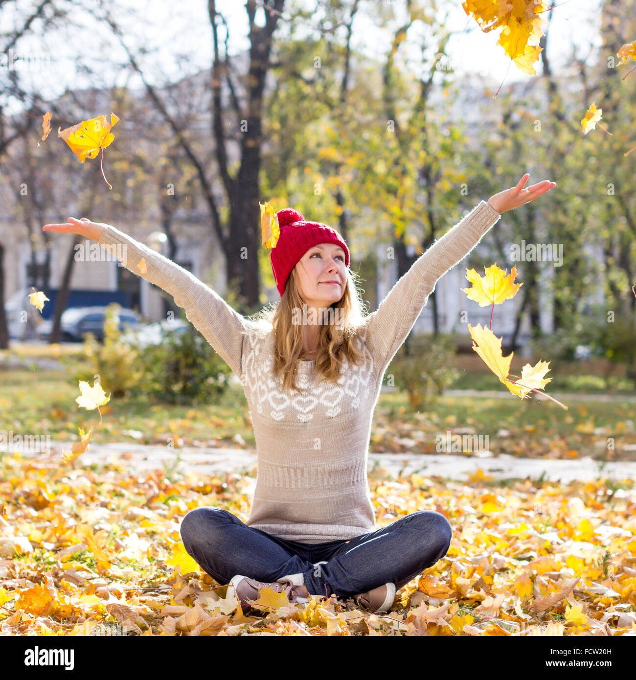 Happy woman with colorful leaves Stock Photo - Alamy
