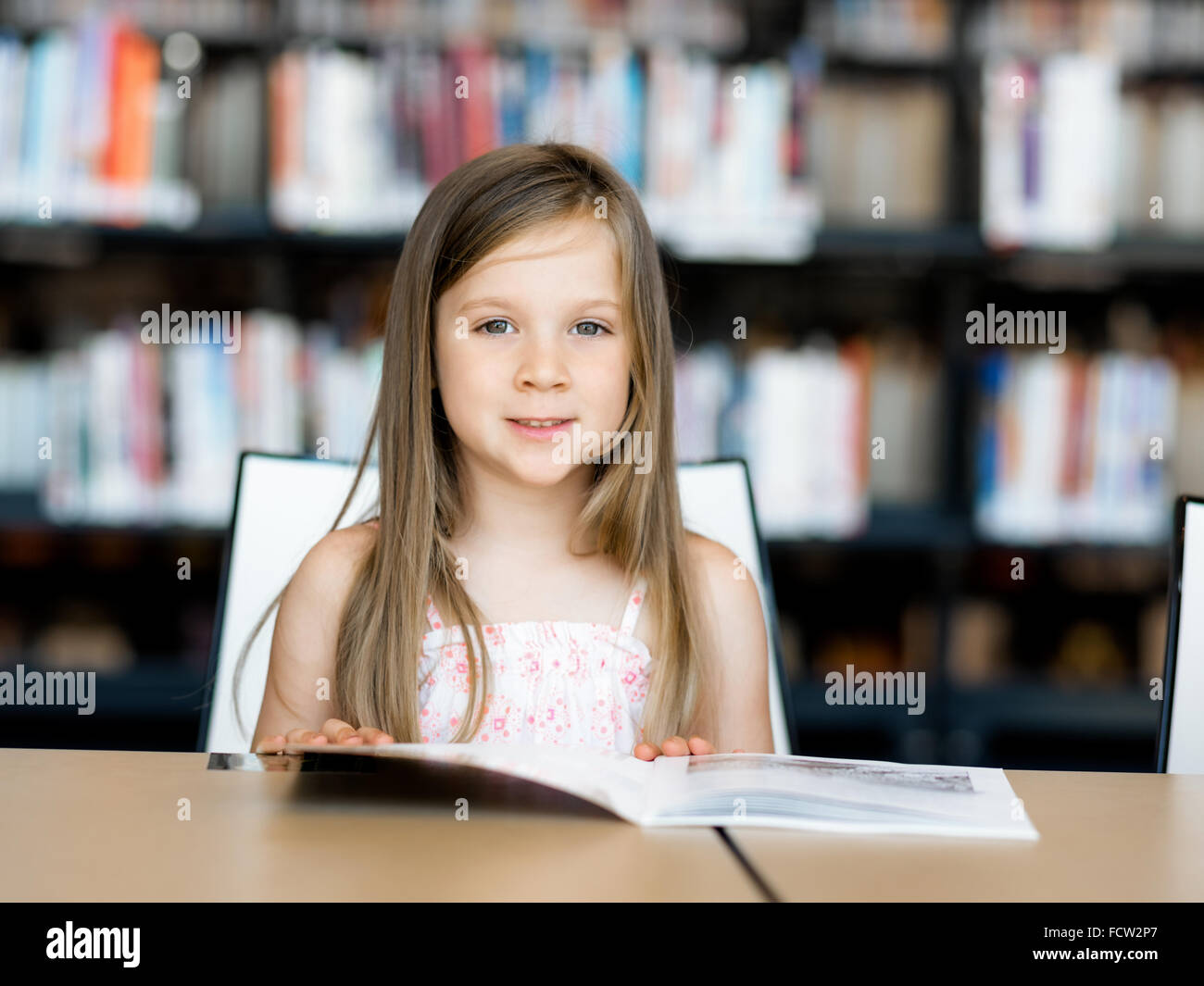Little Girl Reading Books In Library Stock Photo Alamy little-girl-reading-books-in-library-stock-photo-alamy