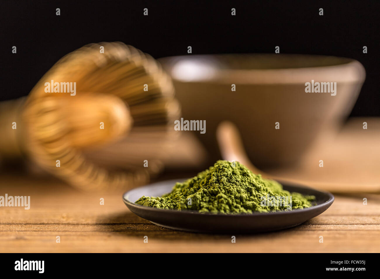 Macha green powder in a plate on wooden table Stock Photo