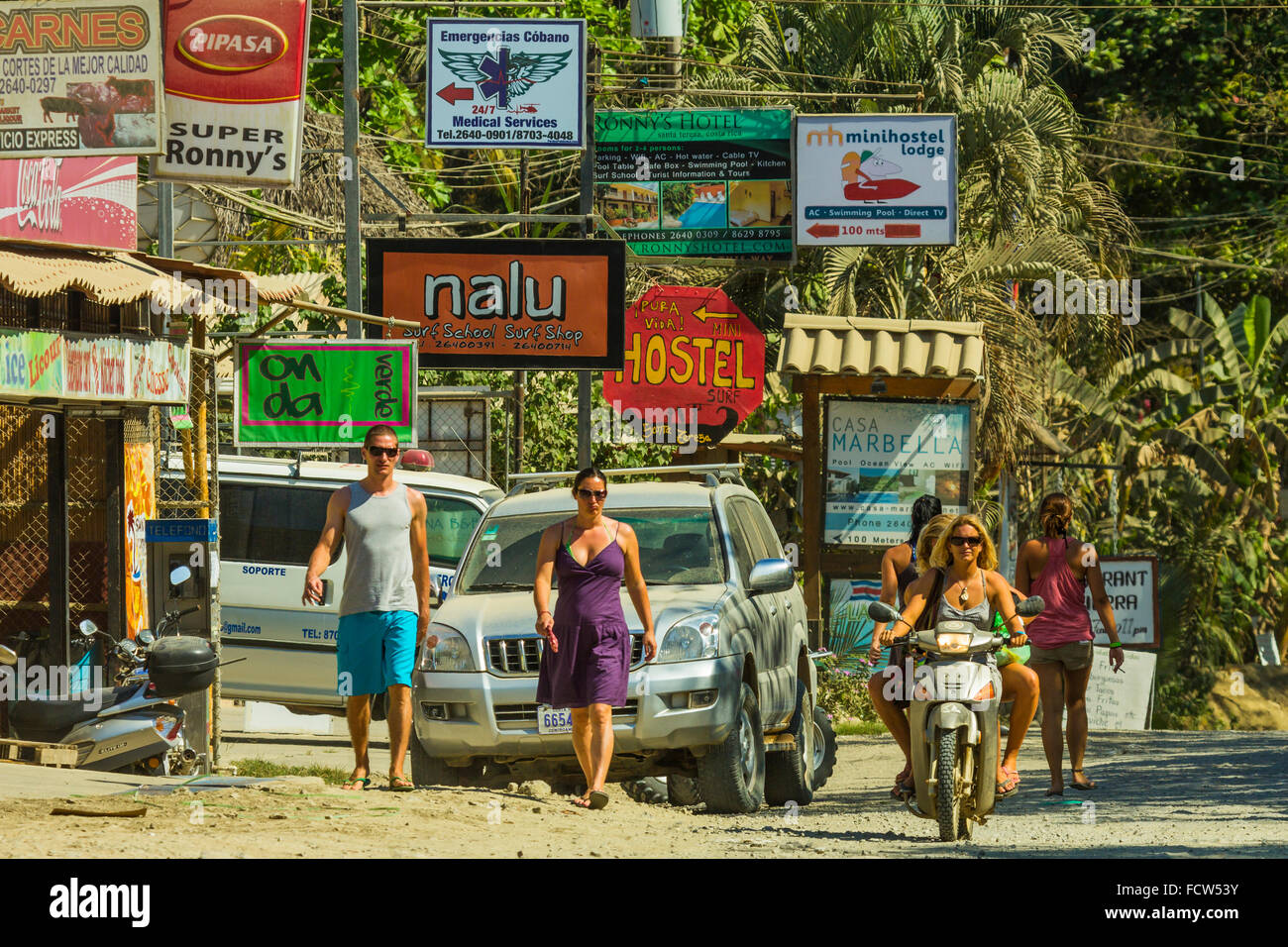 Tourists on the main strip of Santa Teresa on south coast of the Nicoya Peninsula; Playa Santa Teresa, Puntarenas, Costa Rica Stock Photo