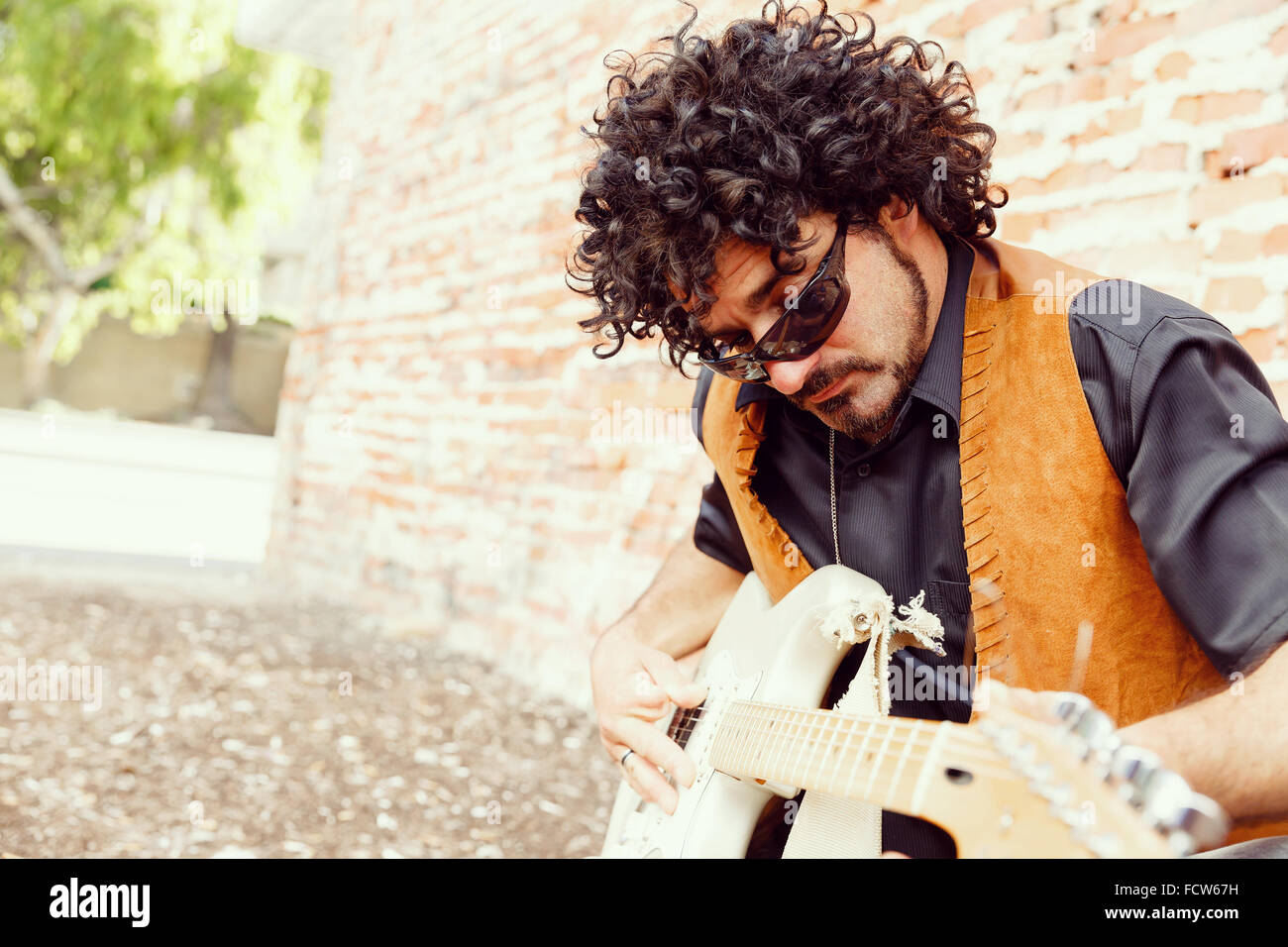 A street musician tuning his instrument Stock Photo Alamy