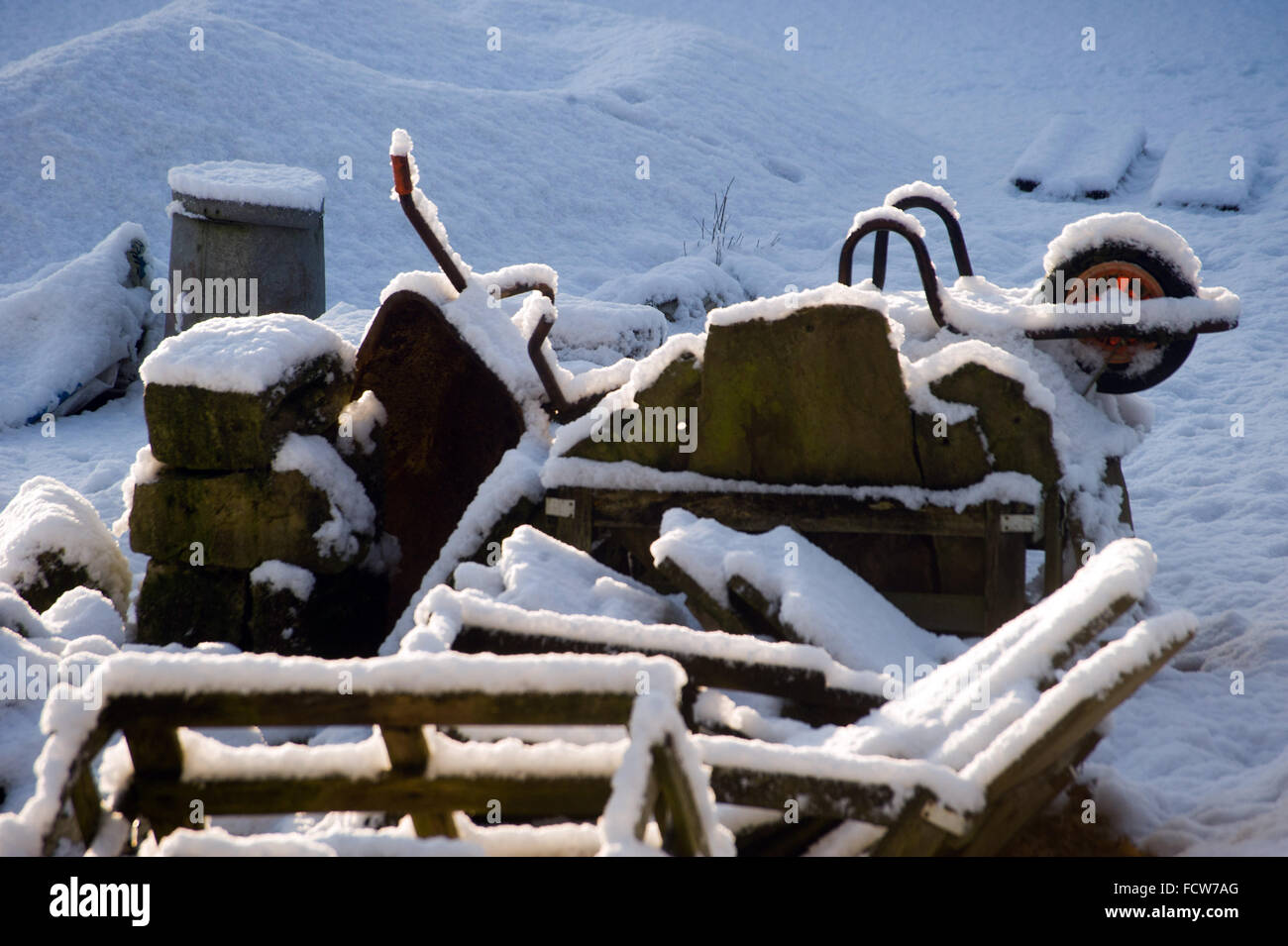 Snow covered wheelbarrow, Northumberland Stock Photo