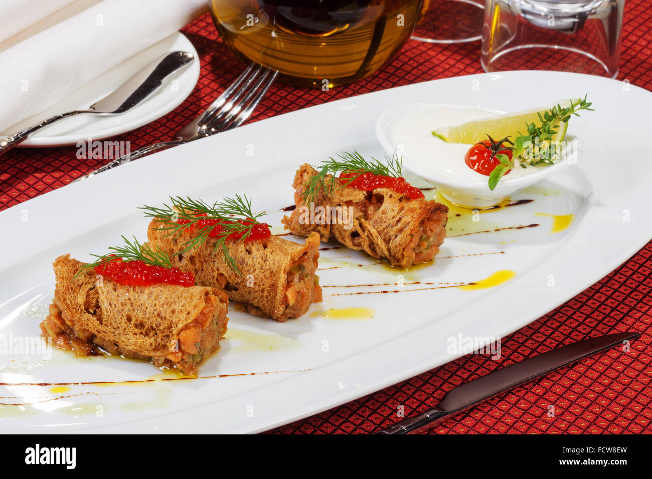 Dish of salmon with bread and red caviar. Blurred background. Stock Photo