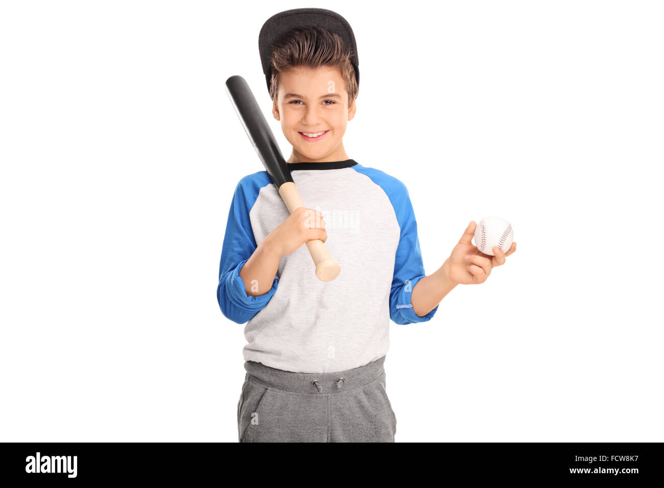 Cheerful kid holding a baseball bat and a baseball isolated on white background Stock Photo
