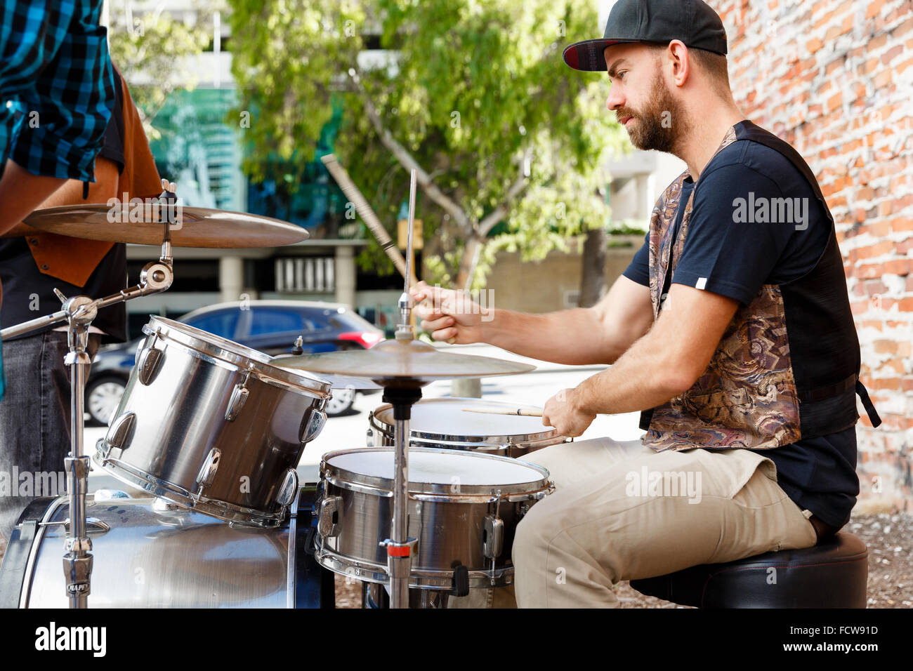 A street muscian playing drums Stock Photo