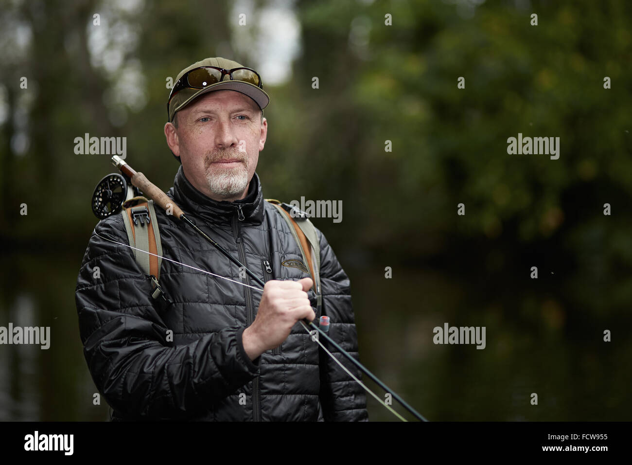 A man fly fishing in a river Stock Photo