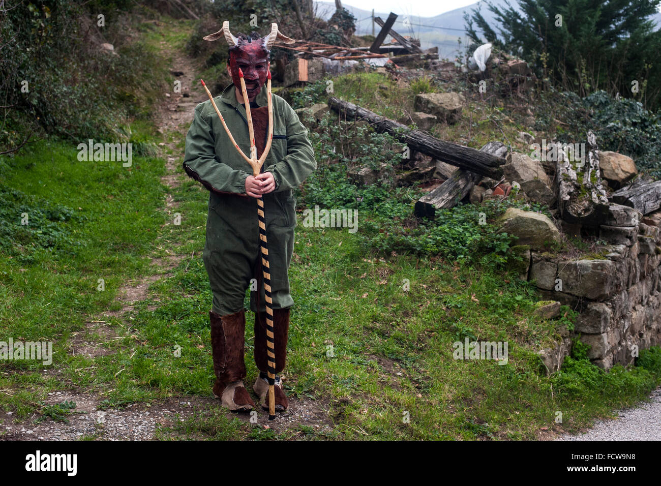 One character Vijanera carnival devil disguised as one of the cottages in the village of Silio (Cantabria). Stock Photo