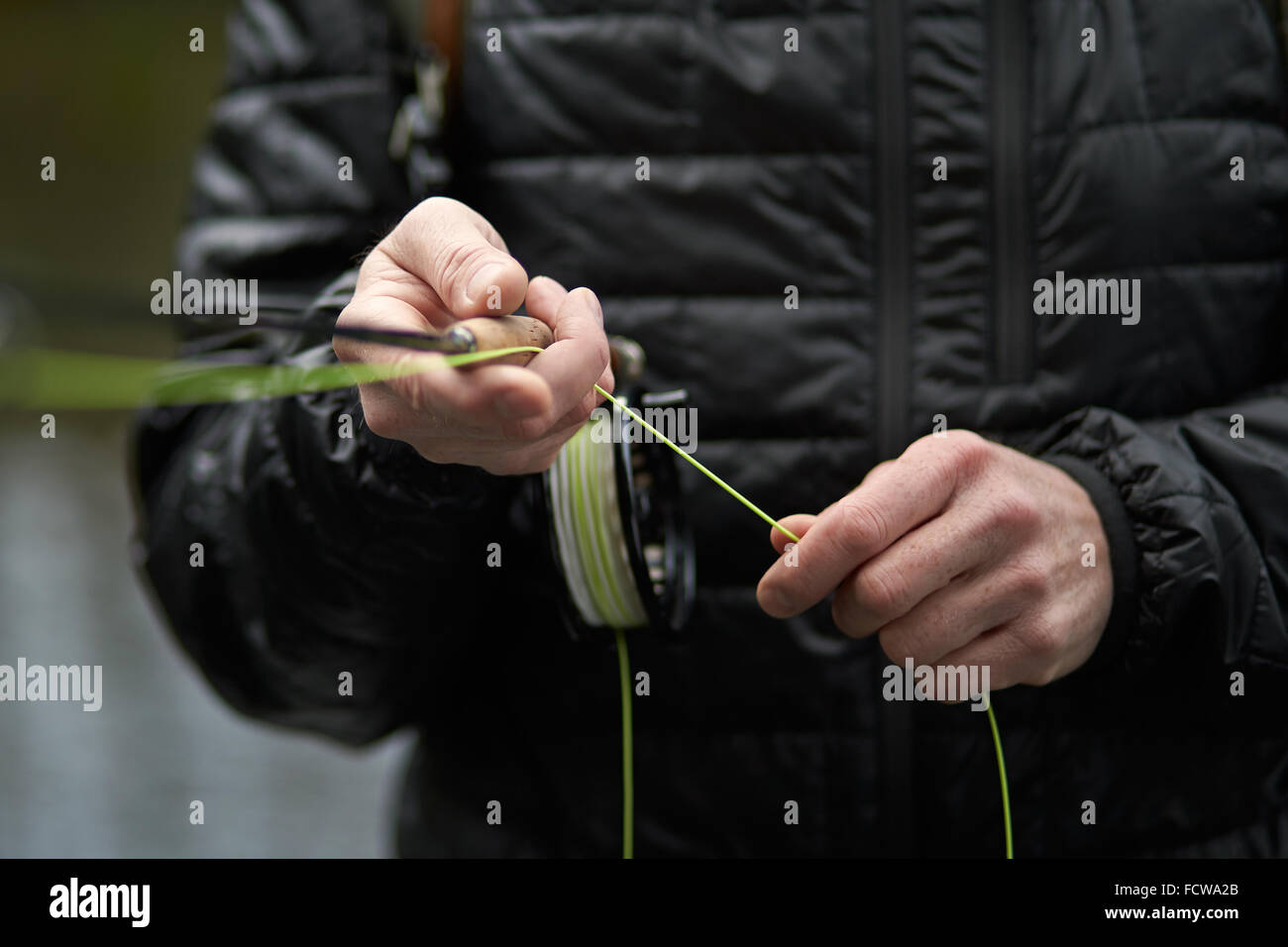 A man fly fishing in a river Stock Photo