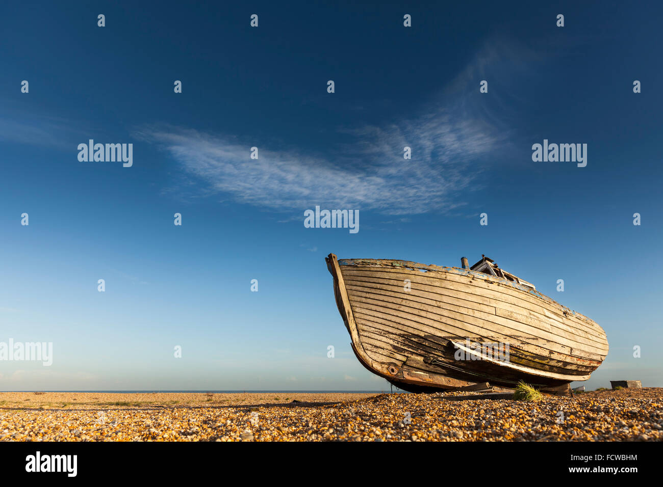 Abandoned old fishing boat on the empty shingle beach in Dungeness ...
