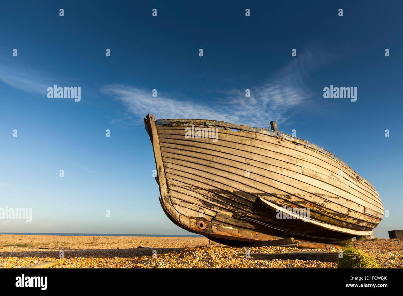 Abandoned old fishing boat on the empty shingle beach in Dungeness ...