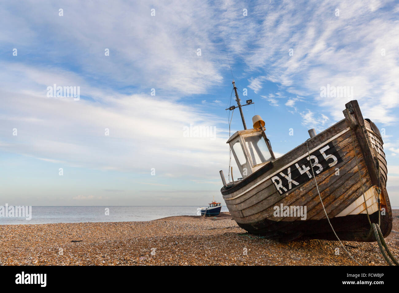 Abandoned old fishing boat on the empty shingle beach in Dungeness ...