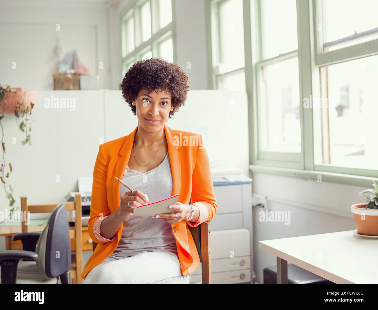 Portrait of young businesswoman in office Stock Photo - Alamy