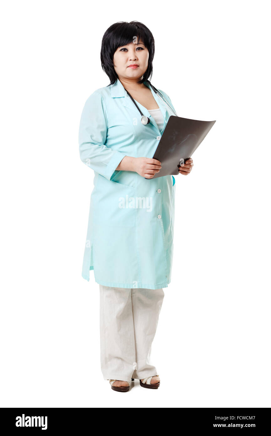 Asian brunette nurse with stethoscope around neck and the x-ray picture of human skull in her hands, provides diagnosis. Radiology, medical data entry, record. Isolated, white background. Stock Photo
