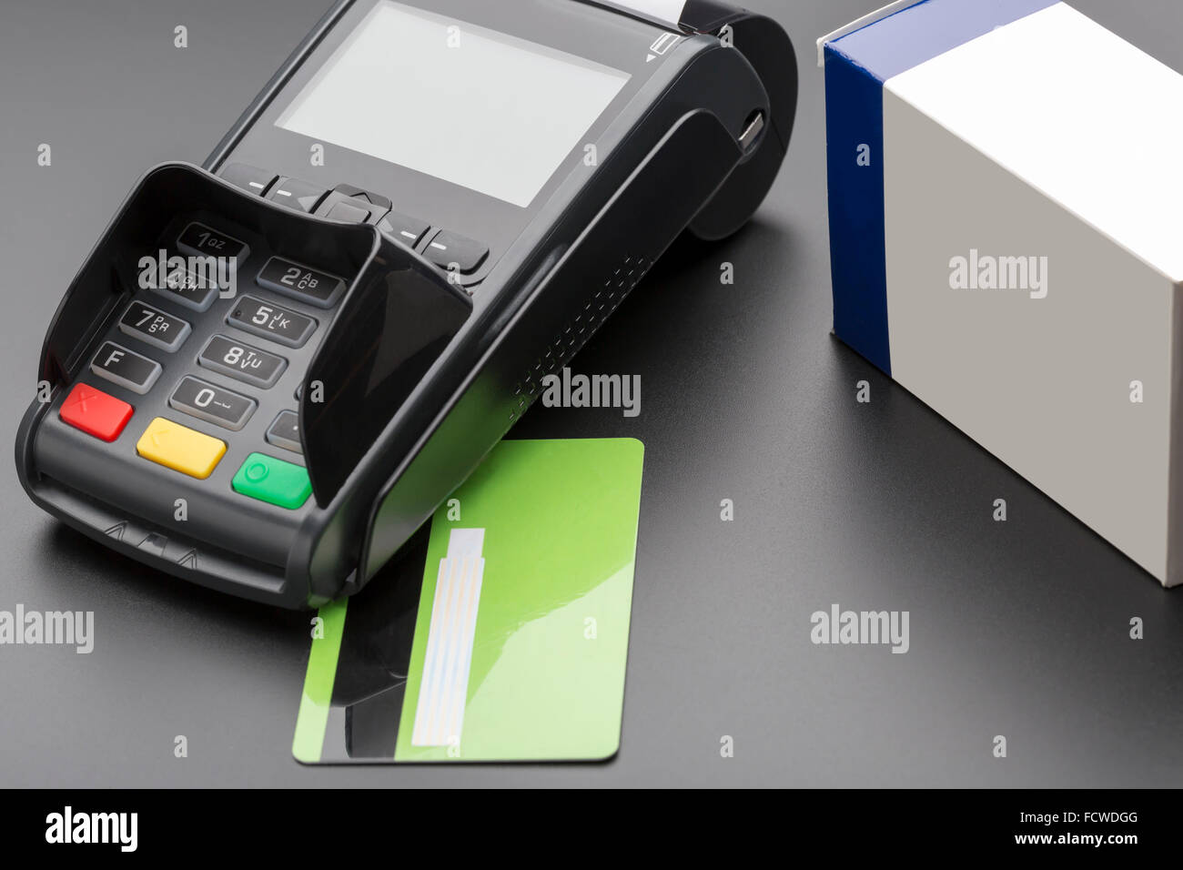 POS terminal, credit card and pill box on black background Stock Photo