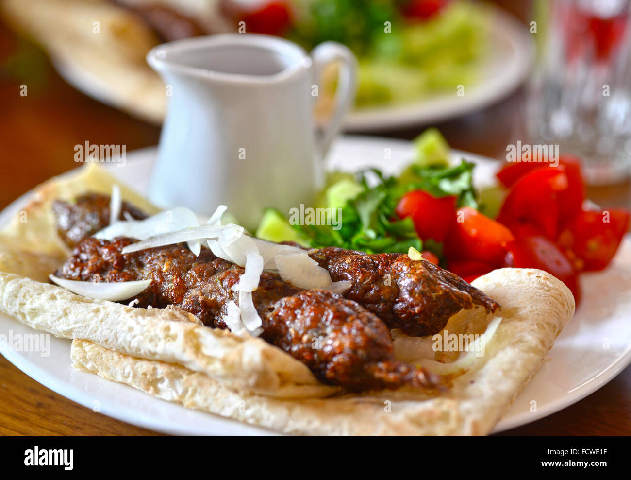 Kebab in pita bread with sauce and vegetables. cuisine