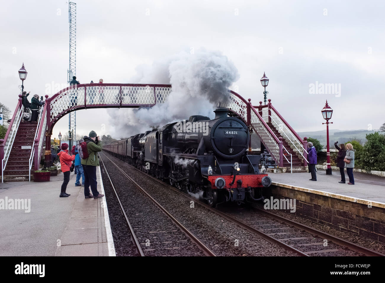 The LMS Class 5MT 4-6-0 44871 steam train speeding through Settle station en route to Carlisle (1) Stock Photo