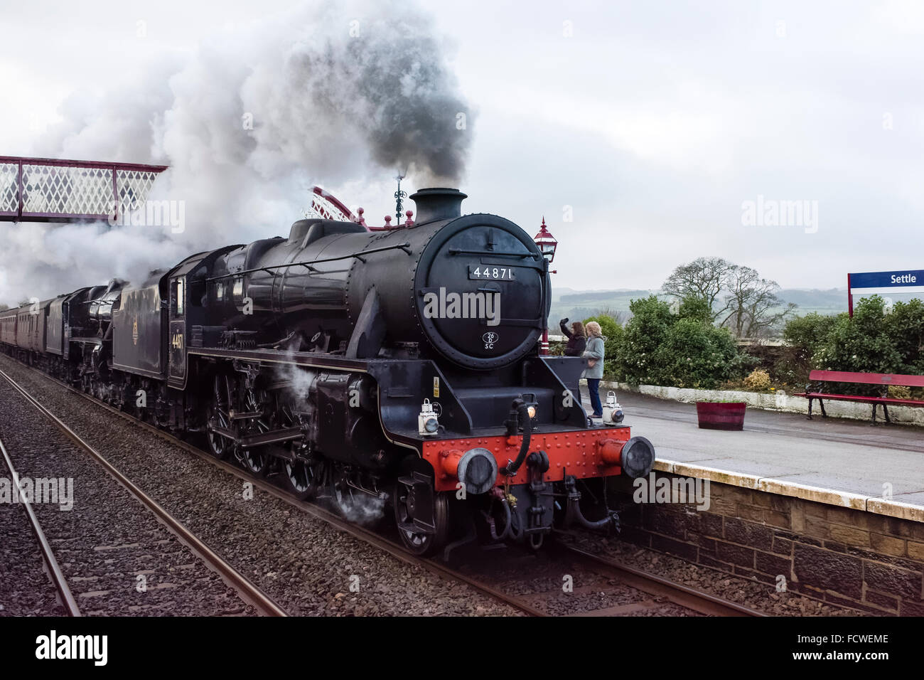 The LMS Class 5MT 4-6-0 44871 steam train speeding through Settle station en route to Carlisle (2) Stock Photo