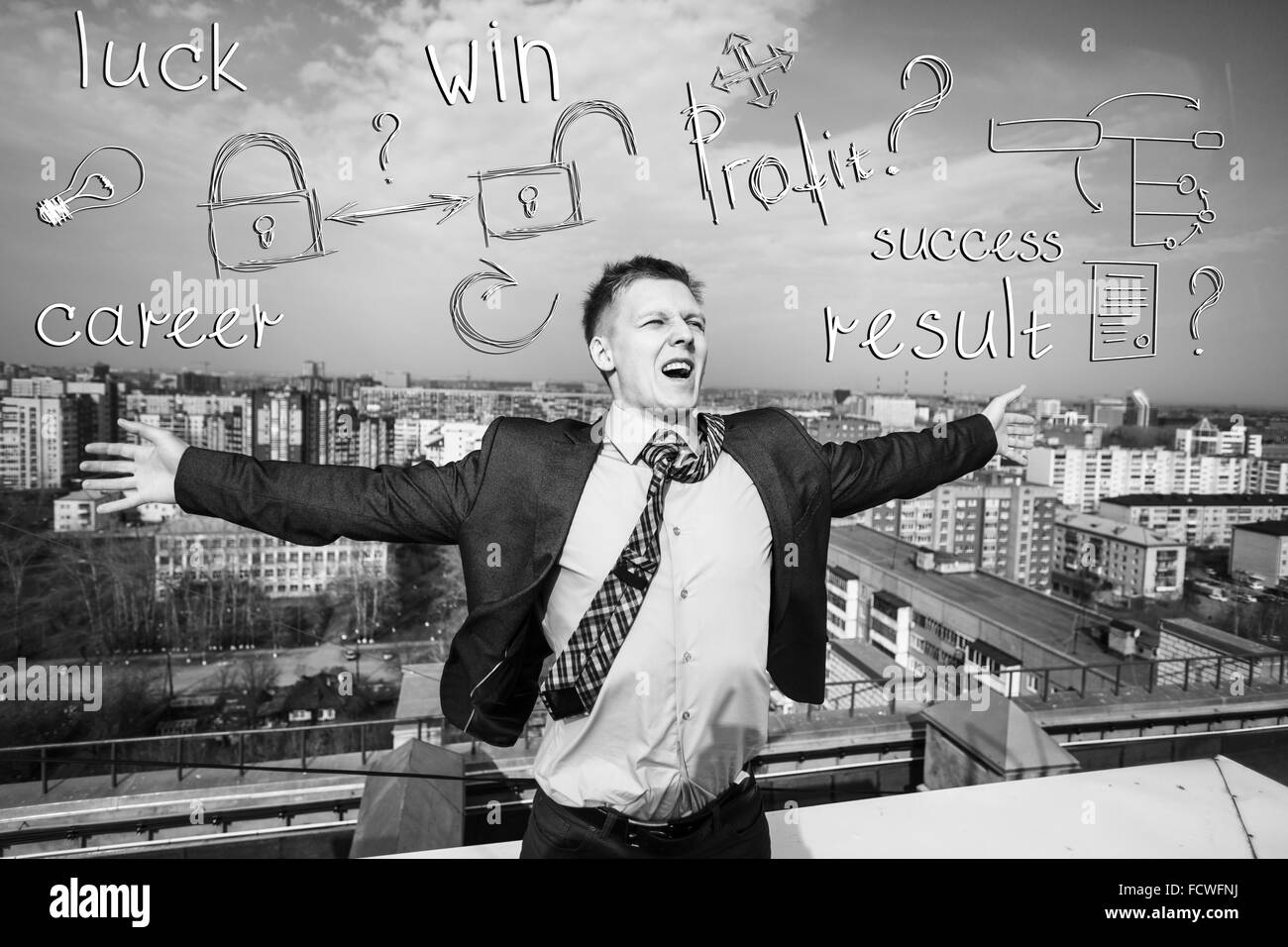 Cheerful businessman standing on the roof with icon overhead Stock Photo