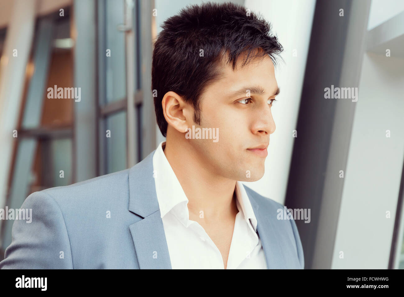 Businessman in office smiling at camera Stock Photo - Alamy